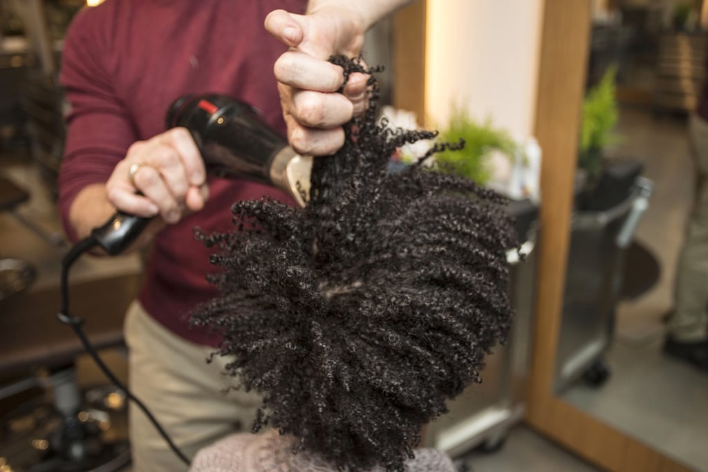 The next step to getting the big hair of your natural dreams is to stretch it with a blow dryer. Focus the heat at your roots while pulling hair from the mid-shaft. In order to prevent frizz, however, try to avoid combing hair with your fingers.