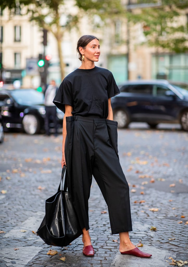 Give your black tee a fresh feel by pairing with structured pants and sleek slides.