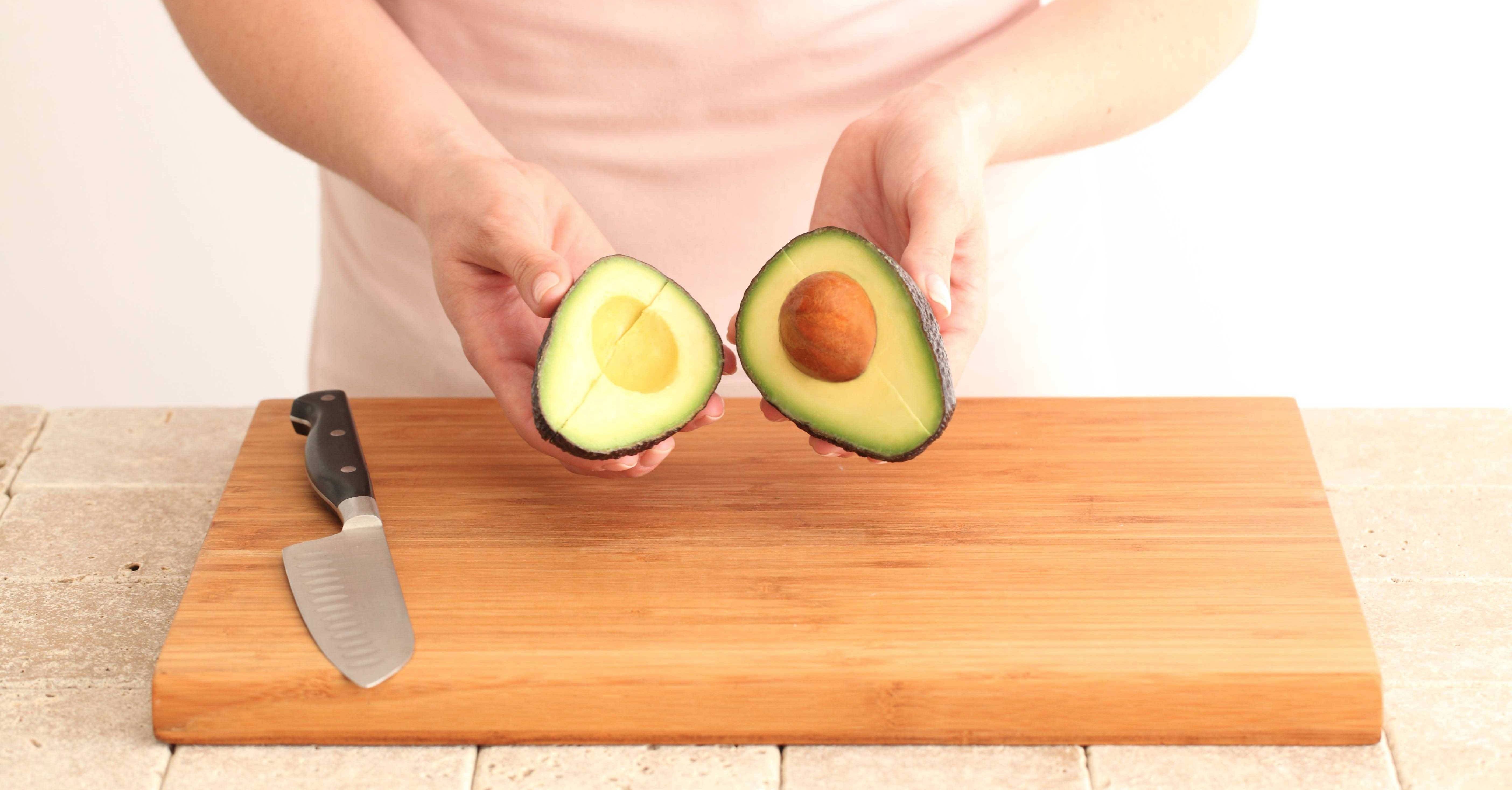 Cut Avocado On Cutting Board With Knife Free Stock Photo and Image 279317778