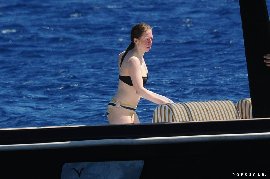 Chelsea Clinton is making the most of Summer! On Saturday, the former first daughter slipped into a bikini for a boat day during her vacation near Sardinia, Italy. Chelsea was joined by her husband, investment banker Marc Mezvinsky, as well as fashion designer Diane von Furstenberg and her husband, Barry Diller.
It's been nearly a year since Chelsea and Marc became parents for the first time when Chelsea gave birth to baby Charlotte last September. She isn't the only former first daughter to give birth in the past year — Jenna Bush Hager welcomed a baby girl on Aug. 13. Read on to see Chelsea's day in the sun, and then scroll through the ultimate celebrity bikini gallery.