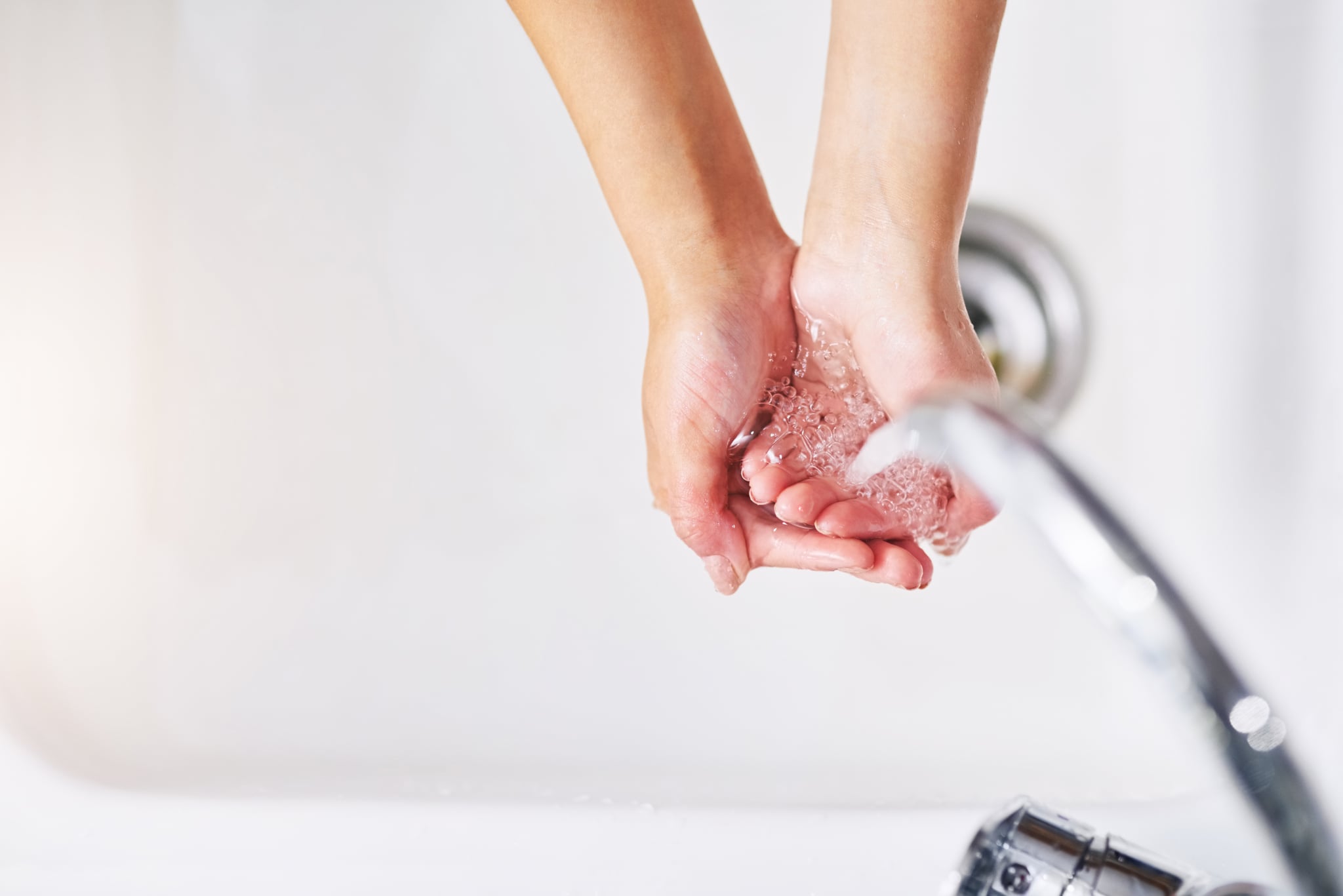 Closeup shot of an unrecognisable woman washing her hands