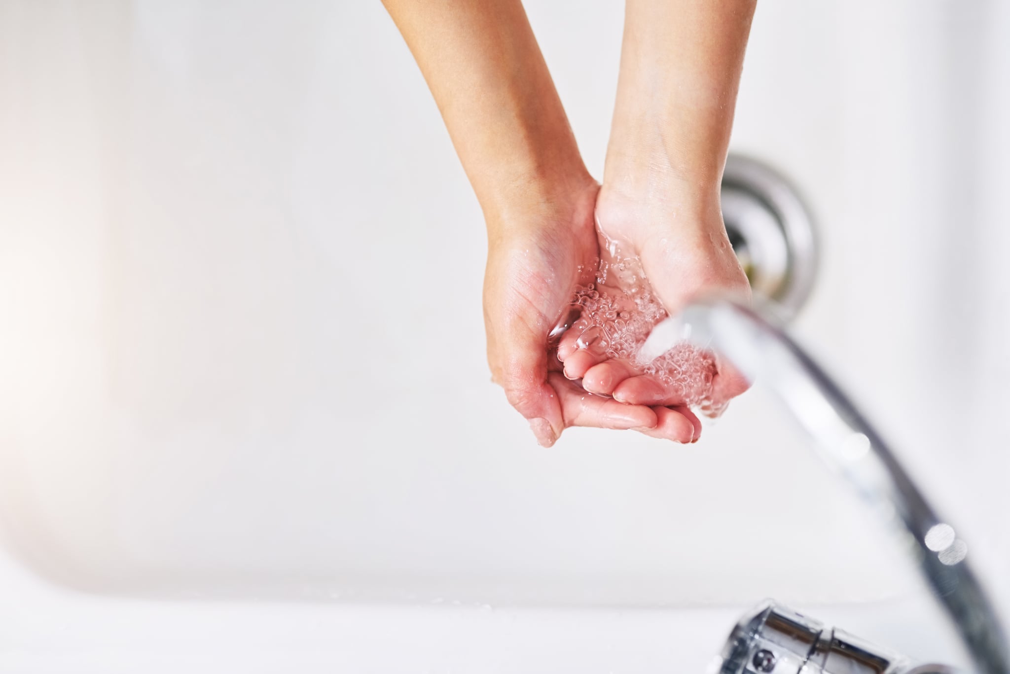 Closeup shot of an unrecognizable woman washing her hands