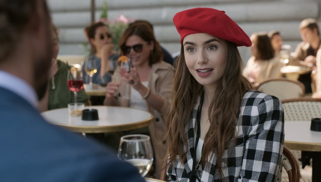 Wearing a checkered black and white blazer with a red beret.