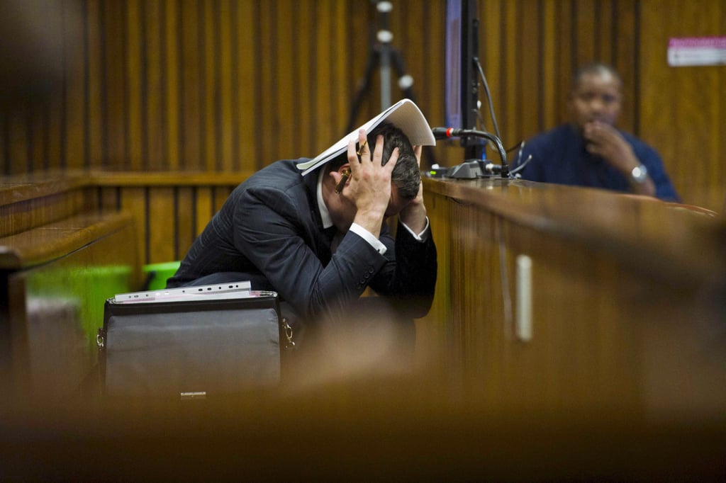 Olympic athlete Oscar Pistorius had his head in his hands during the trial in Pretoria, South Africa, where he pleaded not guilty to murdering his girlfriend.