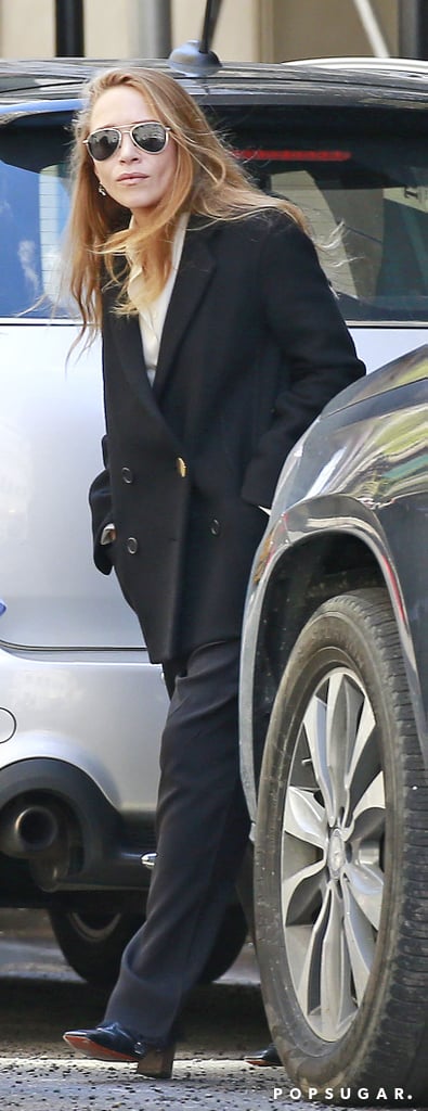 Mary-Kate did a riff on the same look with a double-breasted coat, wide-leg tailored trousers, and block-heeled pumps.