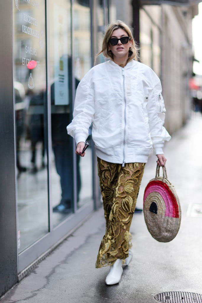 Dress down a smart dress with a straw bag, boots, and bomber.