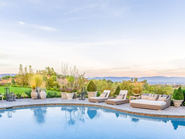From its high vantage point, the home offers dramatic views of the San Fernando Valley city lights and San Gabriel Mountains.