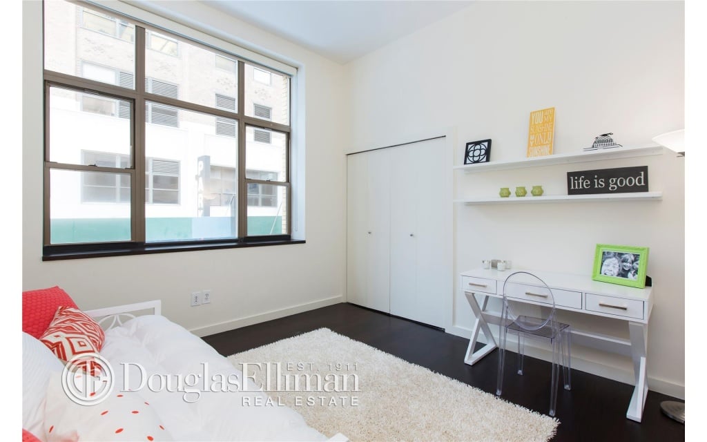 The second bedroom is roomy and light-filled.