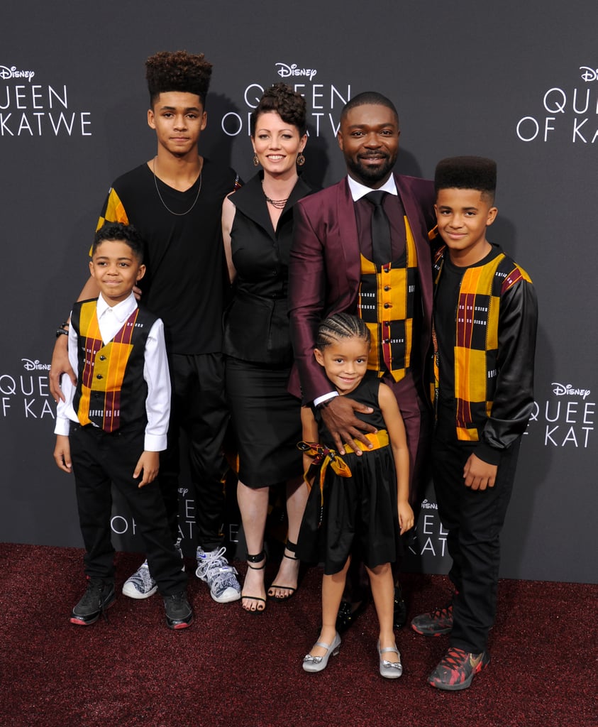 David Oyelowo and his family took matching outfits to the next level. While walking the red carpet for the premiere of his new film, Queen of Katwe, in LA on Tuesday, the actor sported a Dolce & Gabbana suit with a sharp vest made from African Kente fabric, and his four kids also wore the traditional Ghanaian cloth with their outfits. His wife, Jessica, rounded things out in a sleek black dress. David stars as engineer Robert Katende in the Disney film — the movie is based on the life of Phiona Mutesi, a young girl from Uganda training to become a world chess champion — alongside Lupita Nyong'o, whom he met up and posed for photos with at the event; Lupita recently spoke to POPSUGAR about her role as Phiona's mother, Harriet, in the film, saying, "It's a rare privilege to be able to talk to the person you're about to represent in the movie. And one that I was very happy to have."