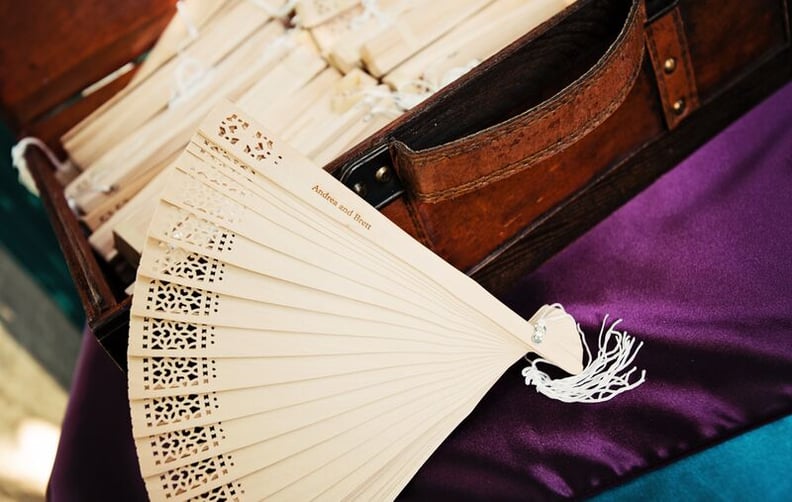 Hand out personalized fans to guests for a keepsake