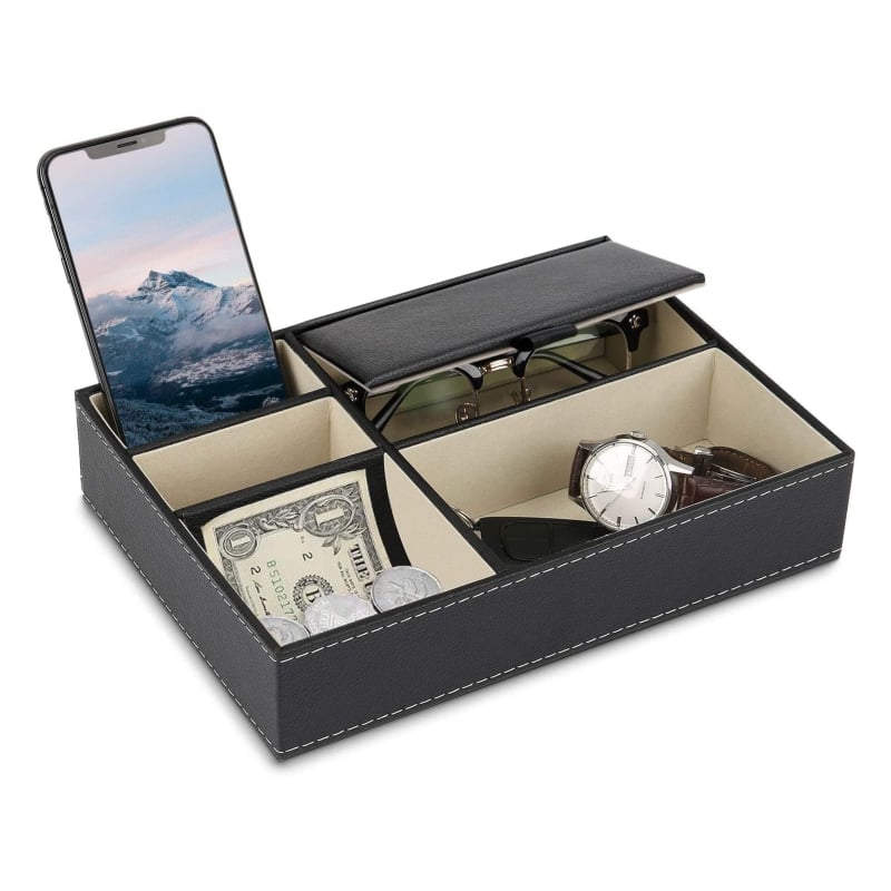 Baoyun Men's Valet Tray Organizer ($16, originally $20)
This tray boasts a sophisticated, faux leather exterior, perfect for storing their essentials, such as watches, glasses, chargers, and other necessities. It comes in three colors (brown, black, and a black and gray combo) and has five built-in compartments of different sizes.