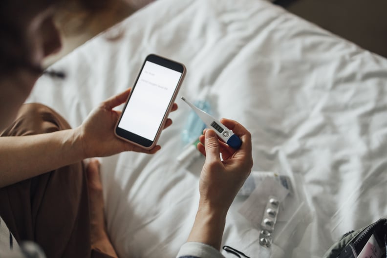 An anonymous Caucasian female checking her health condition and sending the report to her doctor using a mobile phone.
