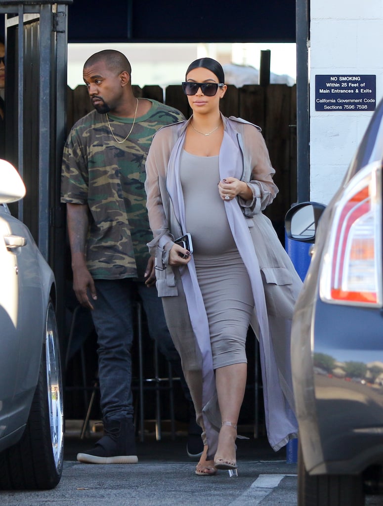 Kim stepped out with Kanye in a gray body-con midi dress. She finished her outfit with a sheer longline cardigan that perfectly complemented her Lucite Yeezy heels.