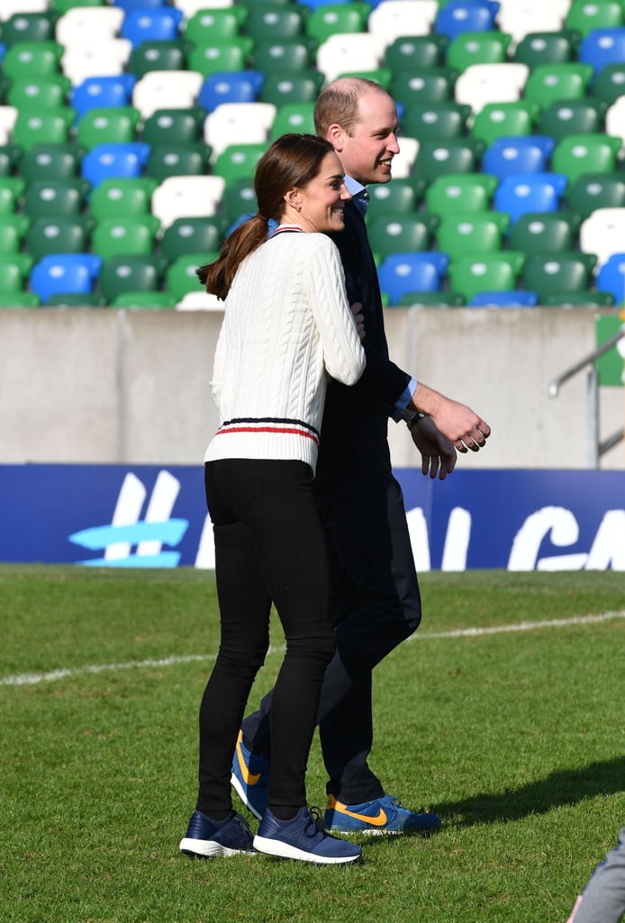 Kate playfully pushed Will on the soccer field as they kicked the ball around with kids in Belfast in February 2019.