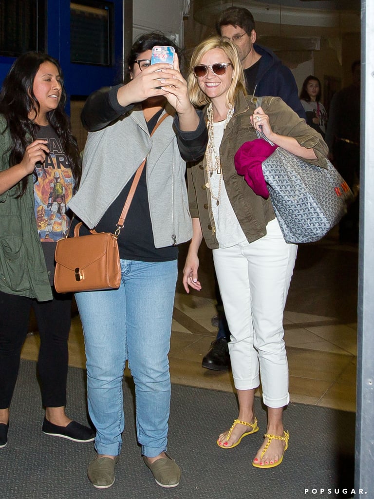 Reese Witherspoon snapped a selfie with a fan on Monday when she arrived at LAX.