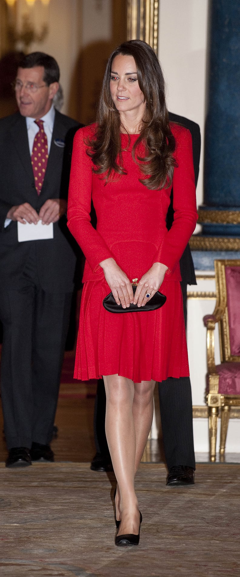 Kate Sprung For a Red Pleated Alexander McQueen While at Buckingham Palace; It Was Her Second Time Donning the Bold Number