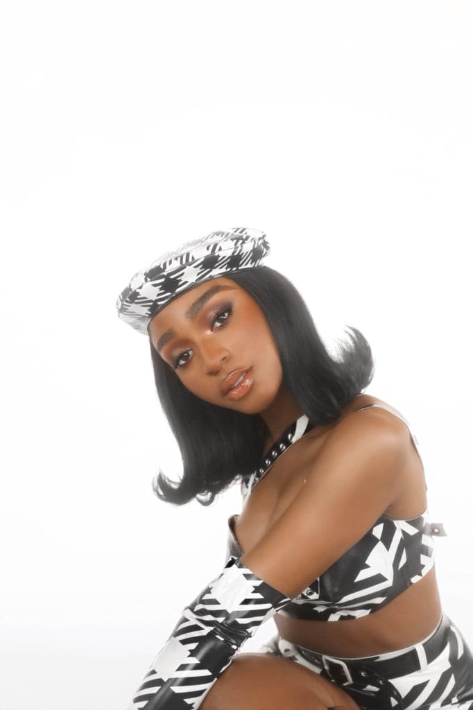 With that in mind, it should come as no surprise that Normani's beauty idol is Rihanna. "Not only is she daring and willing to try out any beauty look (and never fails to pull it off), but she fearlessly turned her passion in the beauty space into an enterprise," said Normani. "I always look to her for inspiration and admire the way she uses makeup as a form of self-expression."
For the "WAP" music video, she wanted to put her own sexy twist on Clueless, which is how she landed on this '90s-inspired ensemble and soft glam. "My stylist Kollin Carter and I were going for a houndstooth theme with the overall aesthetic," said Normani. "Kollin had an Azzedine Alaia reference that he had been wanting to recreate from their 1991 collection — I couldn't be happier with how it was executed."
