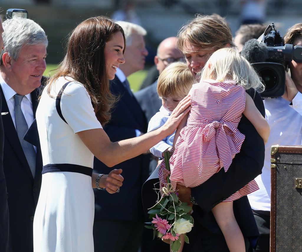 Kate comforted a little girl during a visit to London's National Maritime Museum in June 2014.