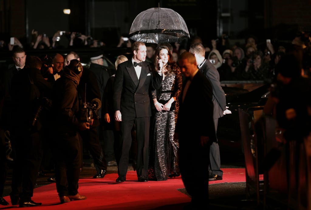 Prince William held the umbrella for Kate at the War Horse premiere