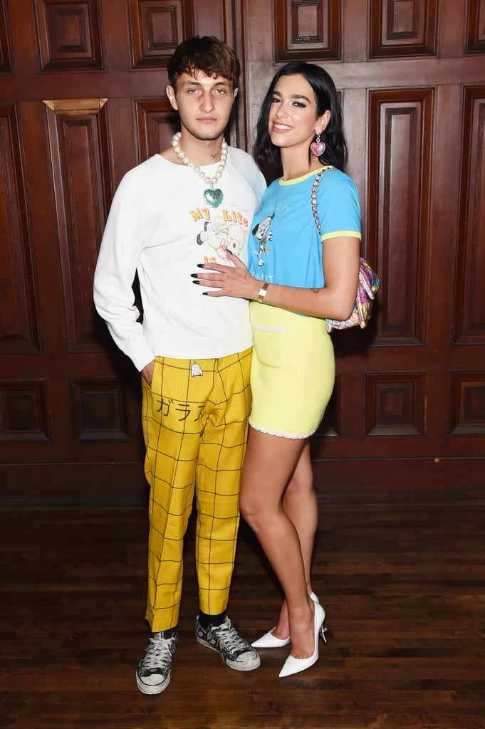 Dua Lipa and Anwar Hadid are going public with their romance. On Wednesday, the duo made one of their first official appearances as a couple as they attended the Marc Jacobs Spring 2020 Runway Show for New York Fashion Week. The couple looked super at ease with each other as they wore color-coordinated outfits and cuddled up for a few photos. They even wore similar heart-shaped jewelry, with Dua's saying "I love you" and Anwar's saying "Kiss me." After posing for the cameras, the two sat front row as they watched Anwar's sisters Bella and Gigi walk during the show.  
Dua and Anwar first sparked romance rumors when they were spotted kissing during the the British Summer Time Hyde Park music festival in London back in July. Since then, they have been growing even closer as they support each other at various events. Anwar proudly cheered on Dua during Amazon Music's Prime Day concert special, and Dua was recently by Anwar's side at his grandmother's funeral in the Netherlands. See more cute pictures from their latest outing ahead. 

    Related:

            
            
                                    
                            

            12 Intriguing Facts About Dua Lipa That Will Further Fuel Your Obsession