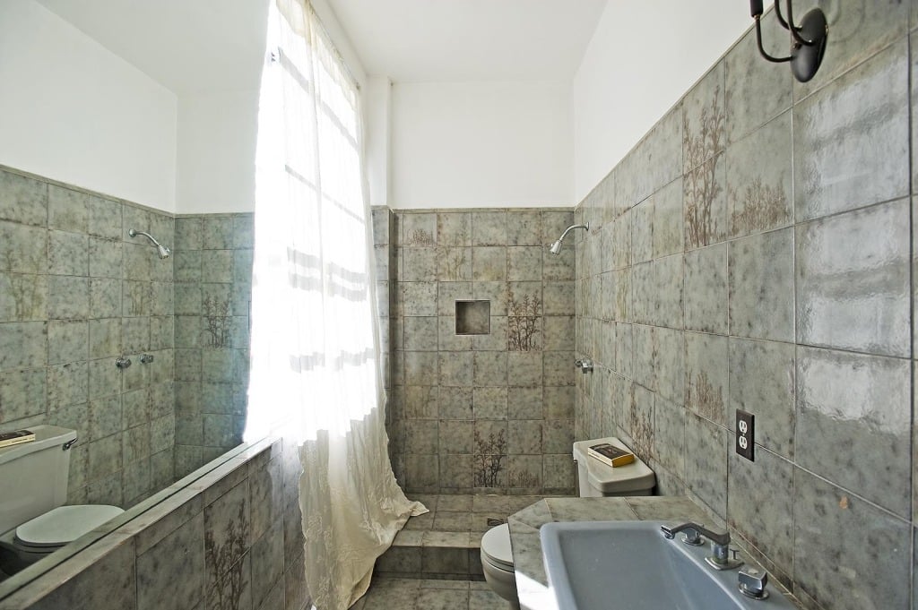 One of 12 bathrooms, this particular space has a spa-style shower. 
Source: Everett Fenton Gidley