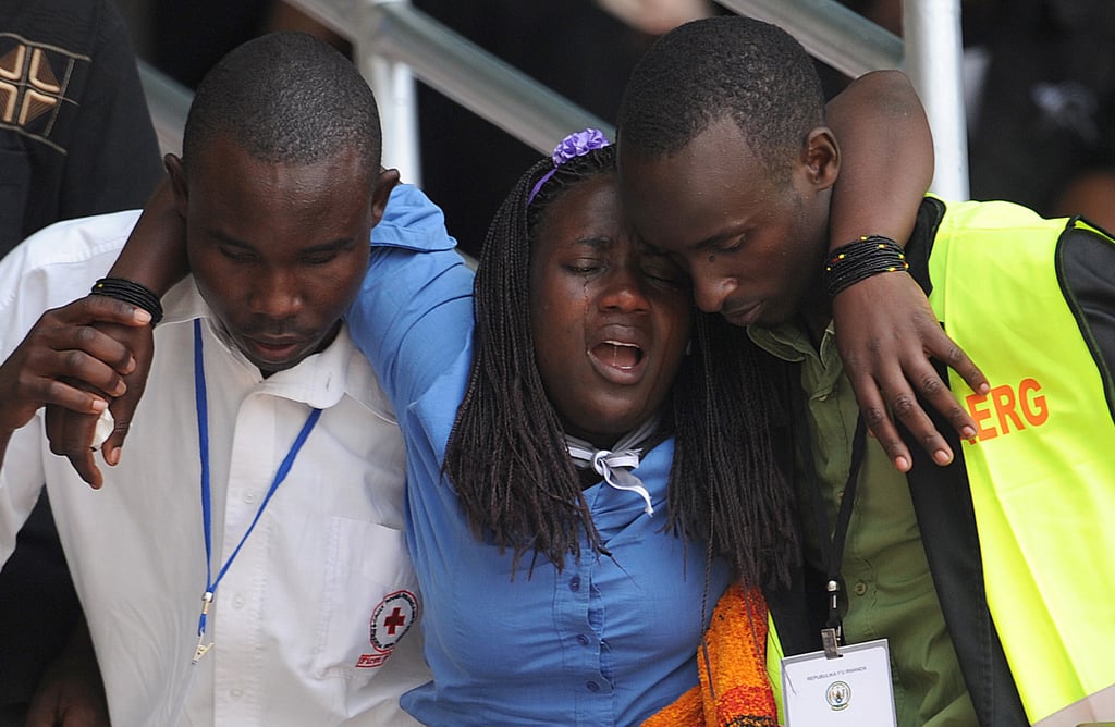 A young woman was helped out of Amahoro Stadium after being overcome with emotion. NPR reported that mourners like her were taken to a special room stocked with mattresses where they could rest.