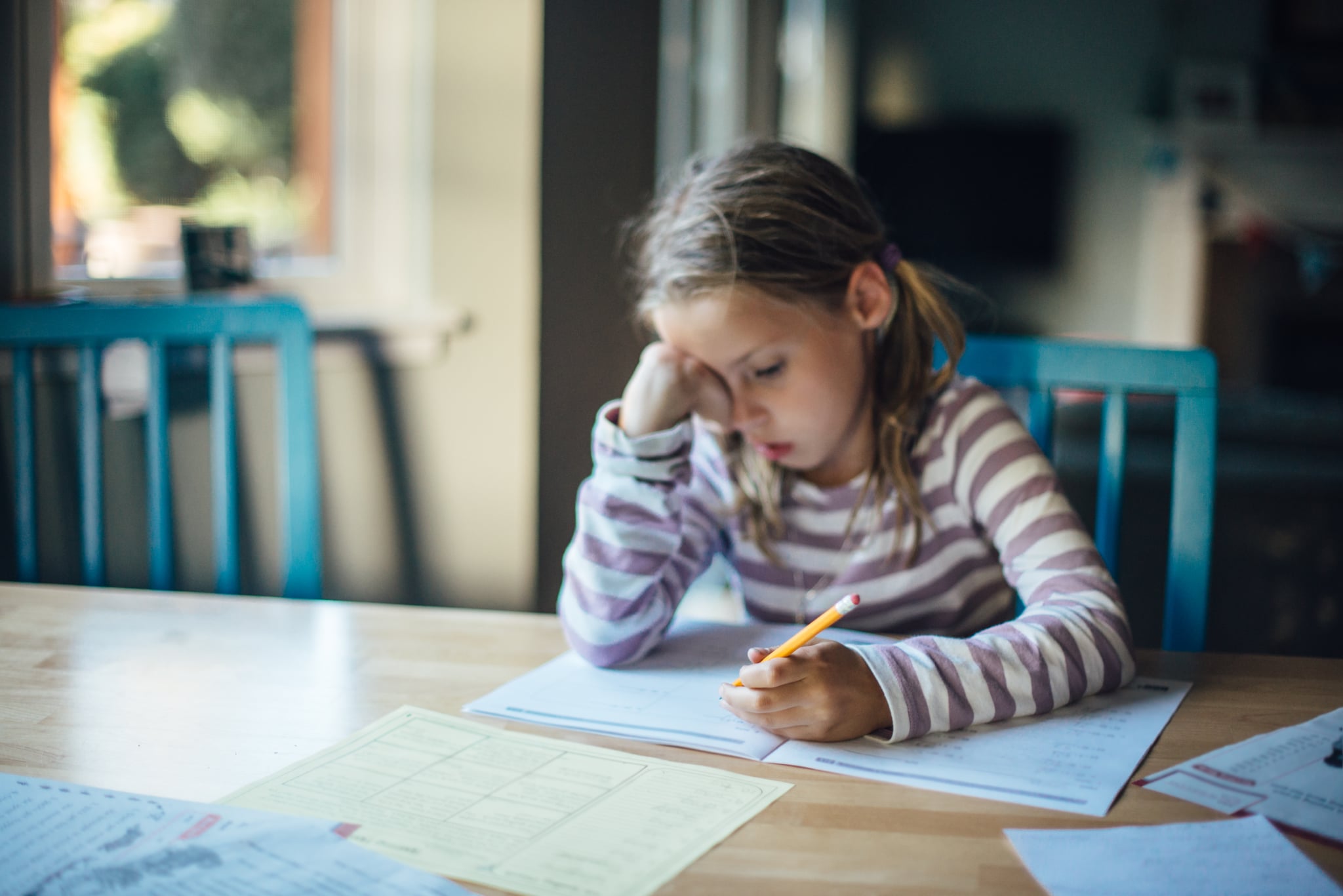 Girl is looking tired while doing homework