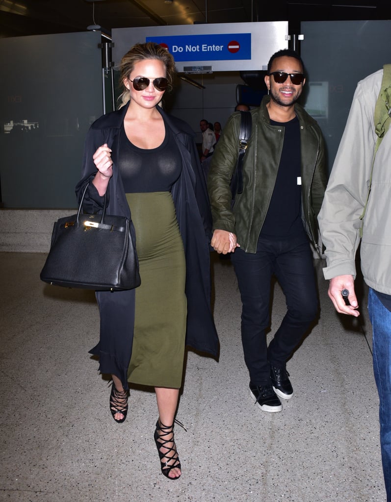 Chrissy arrived at the aiport in her signature pregnancy look, a tight skirt-and-top combo with a long duster coat and strappy sandals.