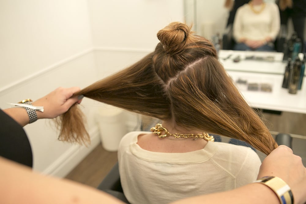Once your hair is mostly dry, section the top of your hair in a V-shape, and then separate the bottom section in half, as shown. You don't have to worry about the parts being perfect.
Source: Caroline Voagen Nelson