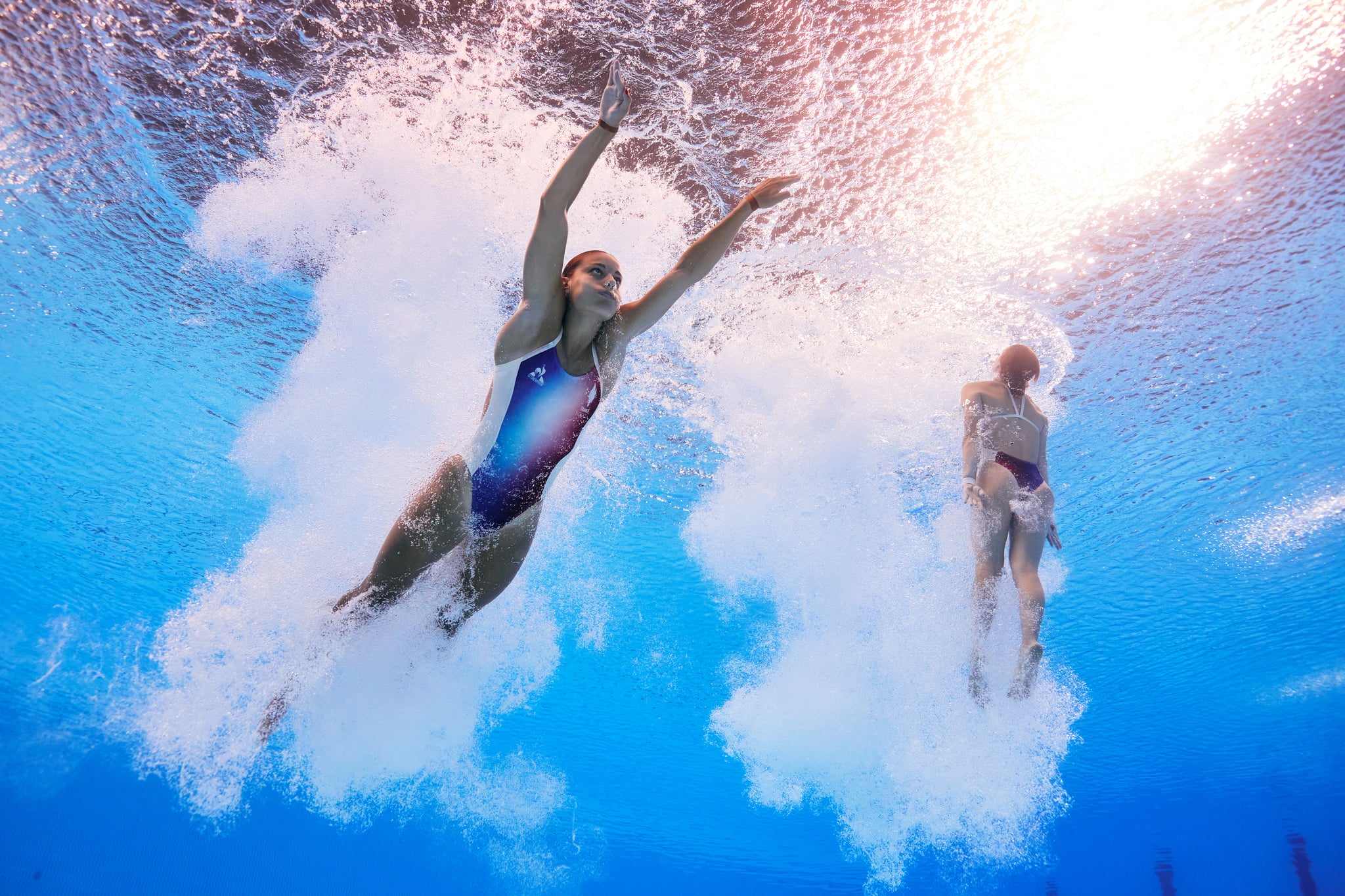 PARIS, FRANCE - JULY 27: (EDITORS NOTE: Image was captured using an underwater robotic camera.) Nais Gillet and Juliette Landi of Team France compete in the Women's Synchronised 3m Springboard Final on day one of the Olympic Games Paris 2024 at Aquatics Centre on July 27, 2024 in Paris, France. (Photo by Quinn Rooney/Getty Images)