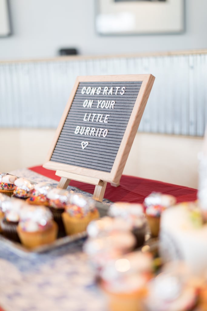 A letterboard that read "Congrats on your little burrito" was propped up in front of the cupcakes.