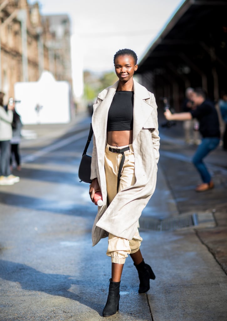 Give Your Trench Coat a Relaxed Look With a Crop Top, Cargo Pants, and Ankle Boots