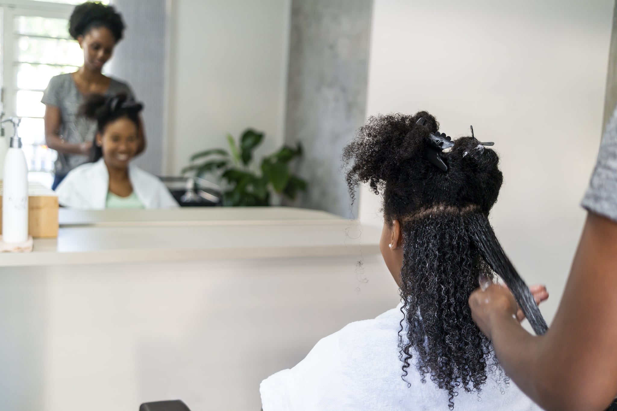 Photo of two brazilian woman. A client and a hair stylist.