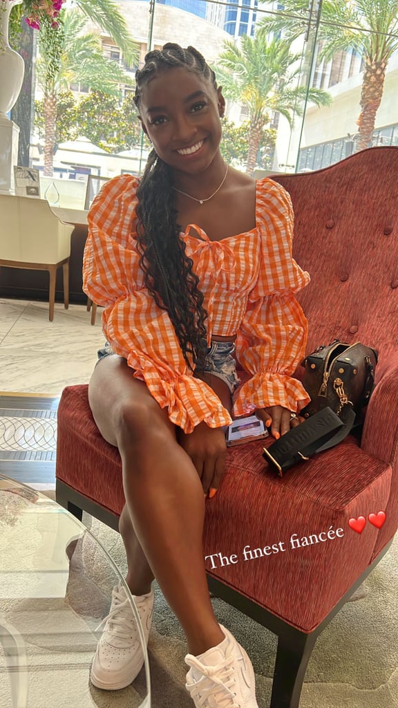 Simone Biles Wearing a Gingham Top, Nikes, and a Louis Vuitton Bag