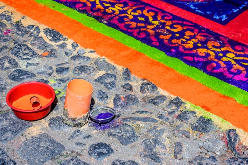 Pots of dyed sawdust & sieve on cobblestones used to make Lent carpet for procession in colonial town with most famous Holy Week celebrations in Latin America.