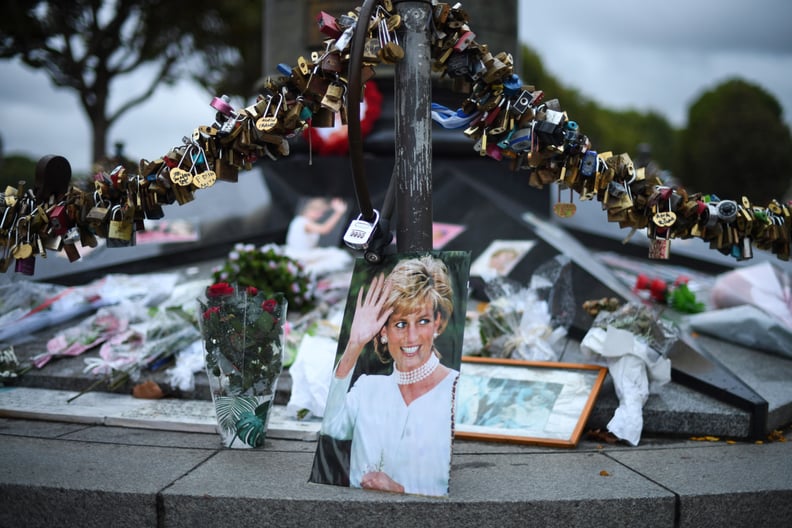 TOPSHOT - Photographs of Diana, Princess of Wales, are seen on August 30, 2017 with locks and floral tributes left over the Alma bridge in Paris  to mark the coming 20th anniversary of the death of Diana who died in a car crash in a nearby tunnel on Augus