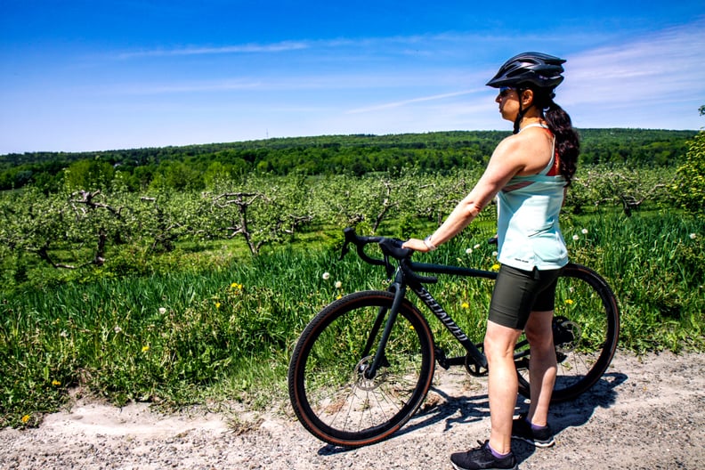 specialized crux expert gravel bike review - woman standing next to Crux pro on gravel road