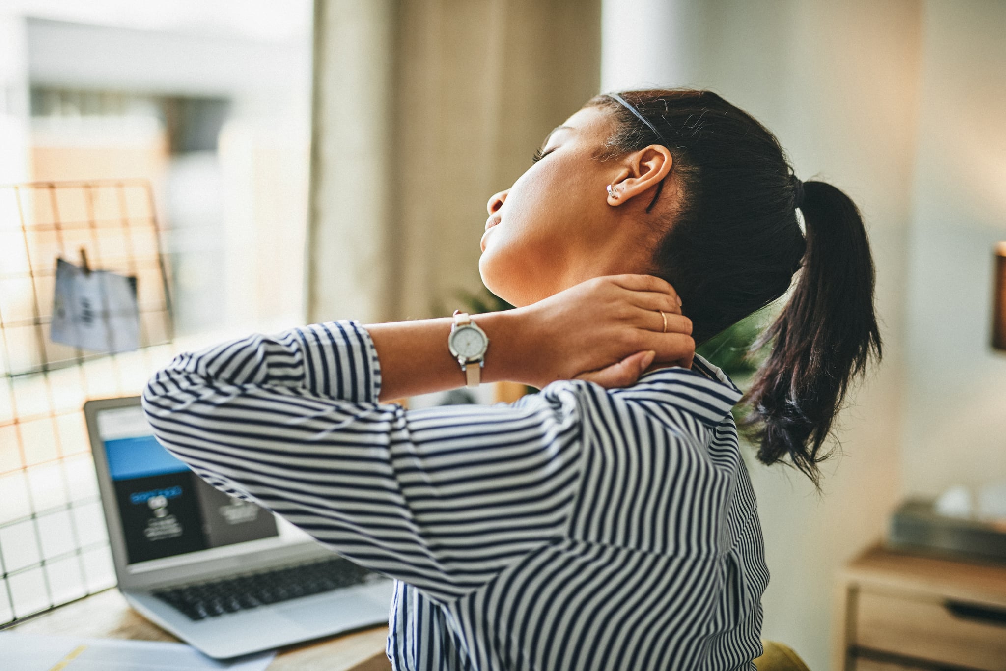 Young woman massageing neck tension headache