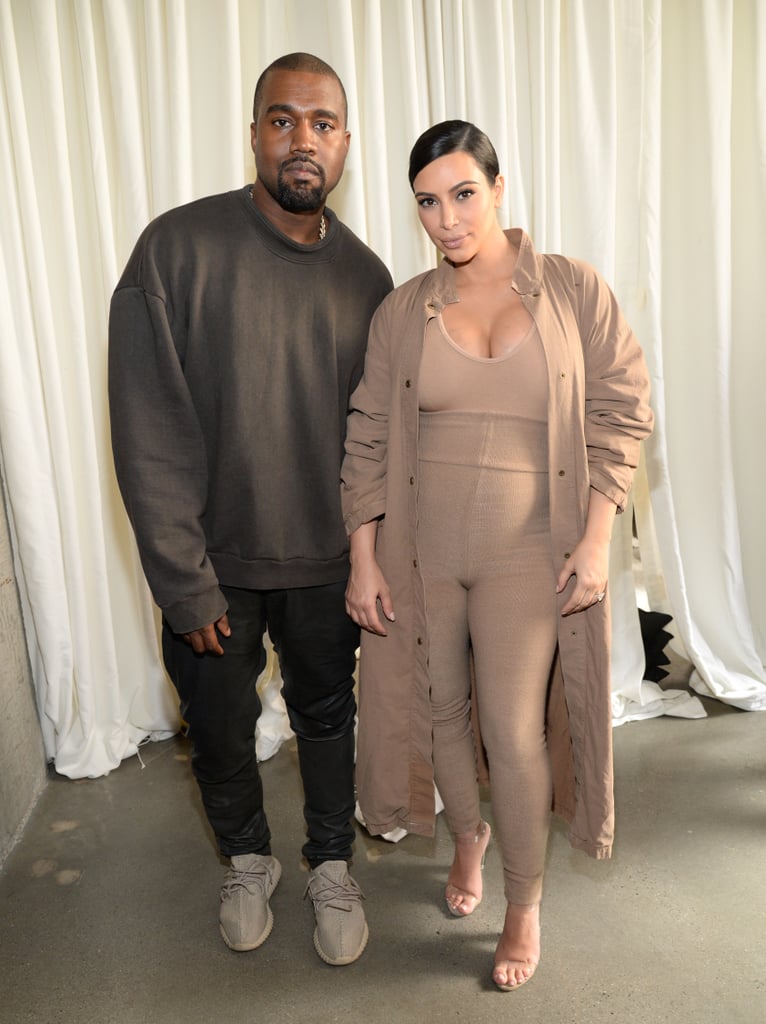 Kim posed with Kanye backstage. Kanye wore a charcoal sweatshirt and slick leather pants to put on his show, completing the look with sand-colored Yeezy Boosts.