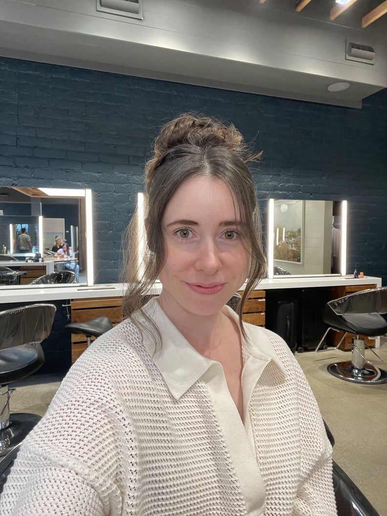 author with hair styled in a loose updo with curtain bangs
