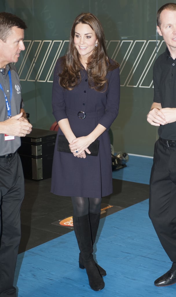 Kate wearing a plum dress and black tights in November 2014.