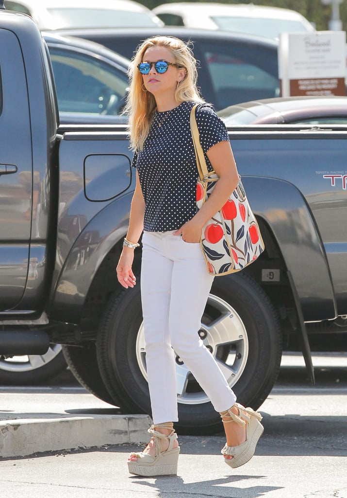 Reese plays up her polka dots with white denim and neutral espadrilles, not strappy black pumps.