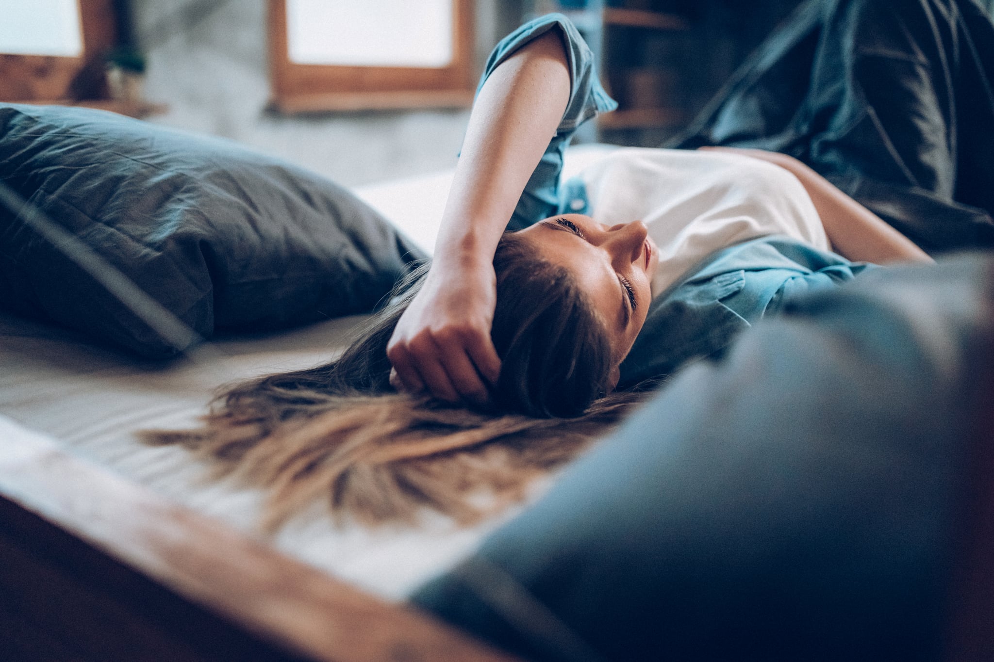 Young women laying on bed