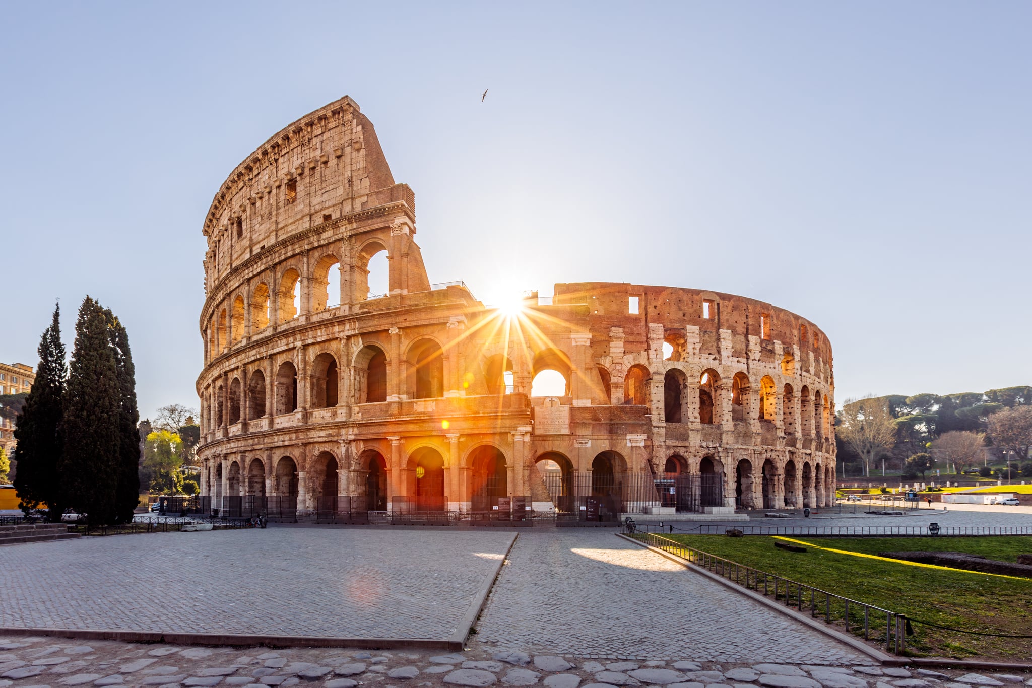 The Roman Coliseum with the sun shining through. Rome is one of the best places to travel in November because it's less crowded during shoulder season.