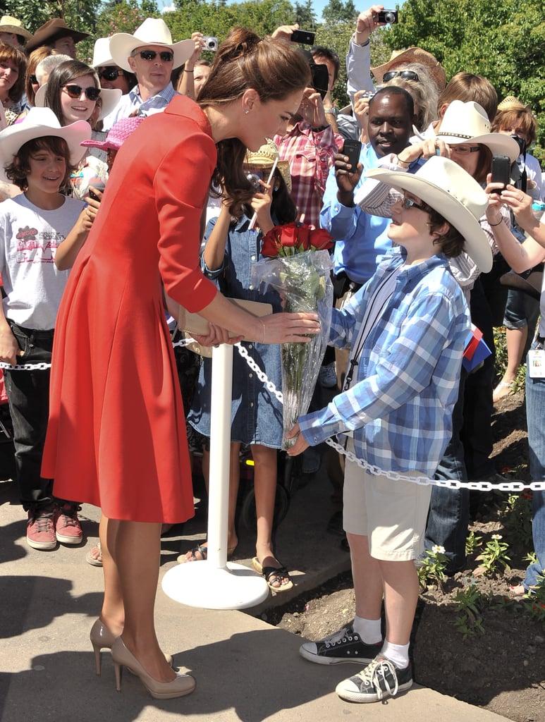 She was greeted by a cute little boy in a cowboy hat at the Calgary Zoo in July 2011.