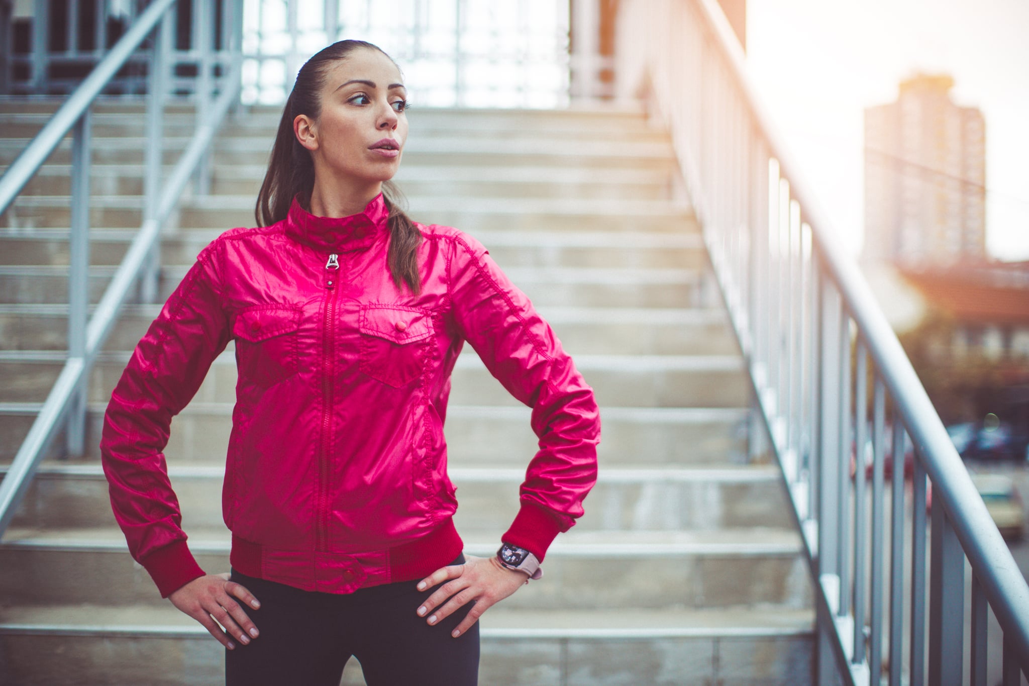 Young woman standing on the stairs and preparing herself for the training