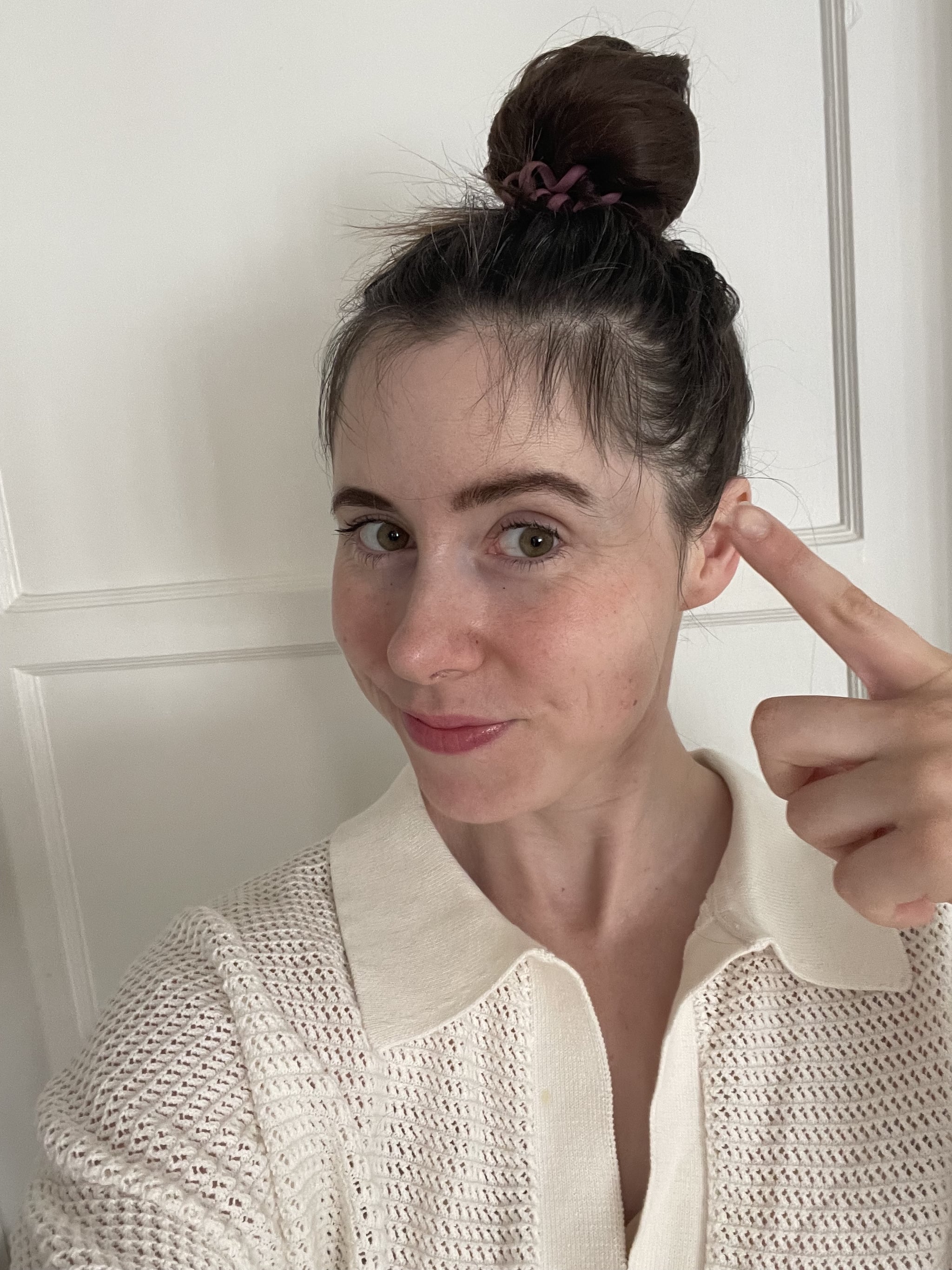 Author with hair in a loose topknot with postpartum baby bangs