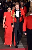 Meghan Markle Colour-Coordinates With Prince Harry in a Red Safiyaa Cape Dress