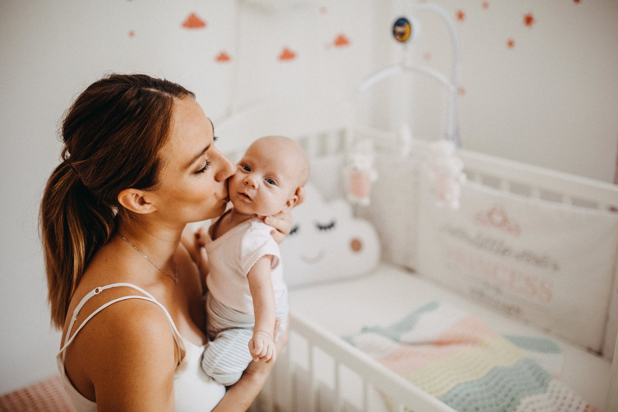 Holding tenderly her newborn baby girl