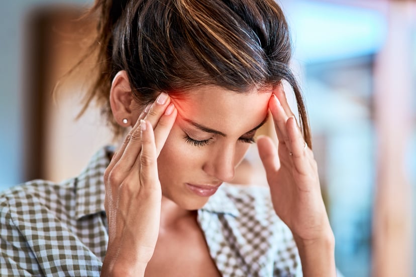 Shot of a uncomfortable looking woman holding her head in discomfort due to pain at home during the day
